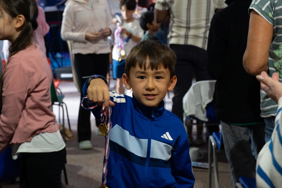 A smiling young boy giving during a Sunday service