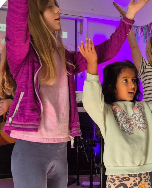 Children worshipping with hands raised