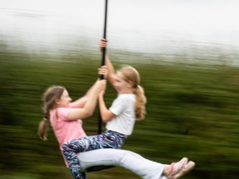 Two girls sharing a zipwire ride at the Connect Weekend Away